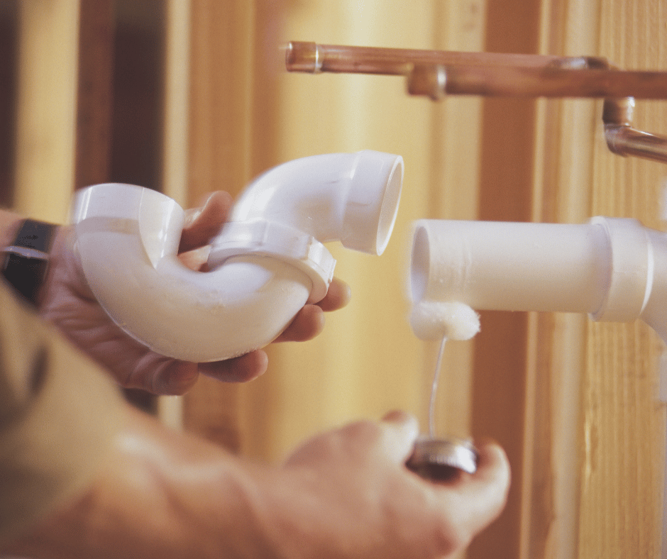 a Vancouver plumber connecting PVC pipes