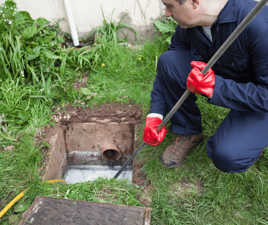 a plumber unlocking an outdoor drain