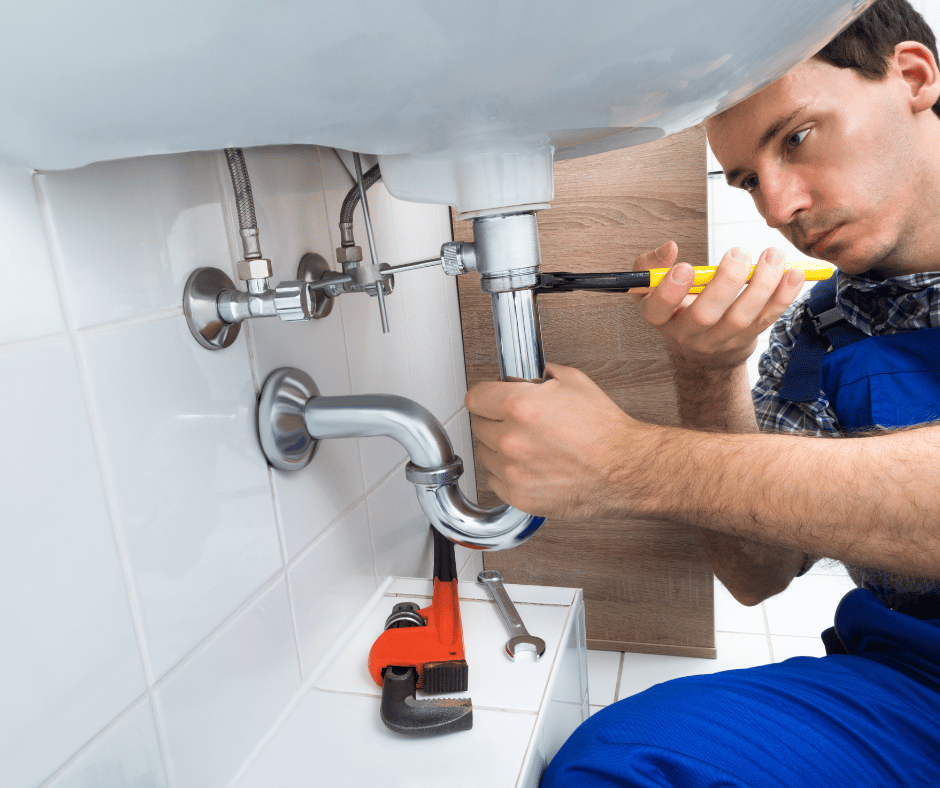 PW plumber fixing a sink in a clients bathroom